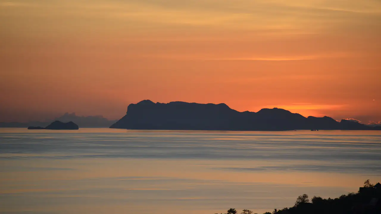 从苏梅岛望去，夕阳落在安通海洋公园的岛屿之后。
